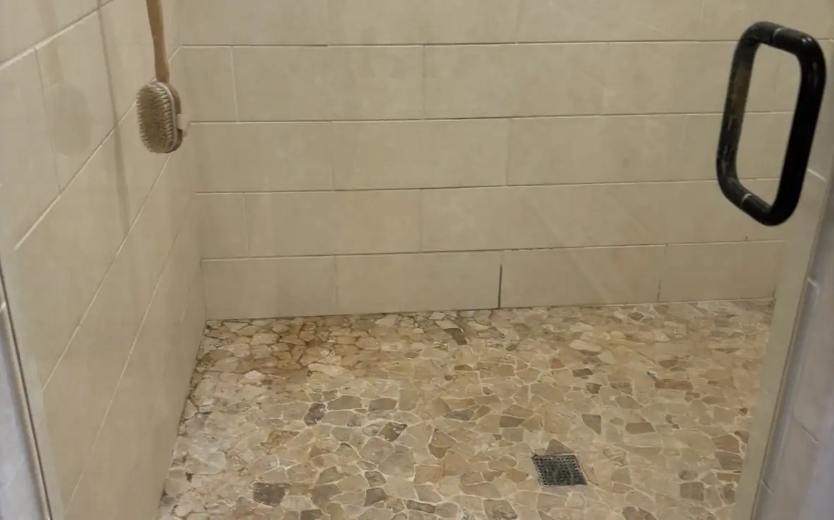 Natural stone shower floor restored